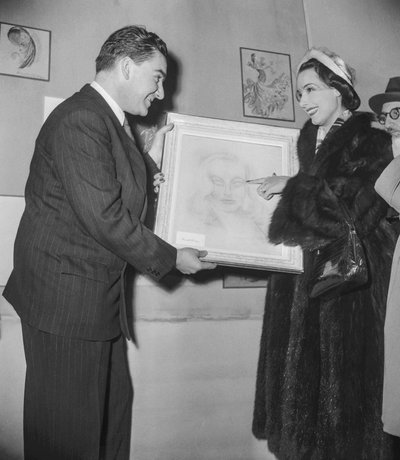 Art exhibition (works of art made by actors), at the Palais des Beaux Arts in Paris, December 16, 1950: French actress Marcelle Derrien showing her canvas to the director of the exhibition by Unknown
